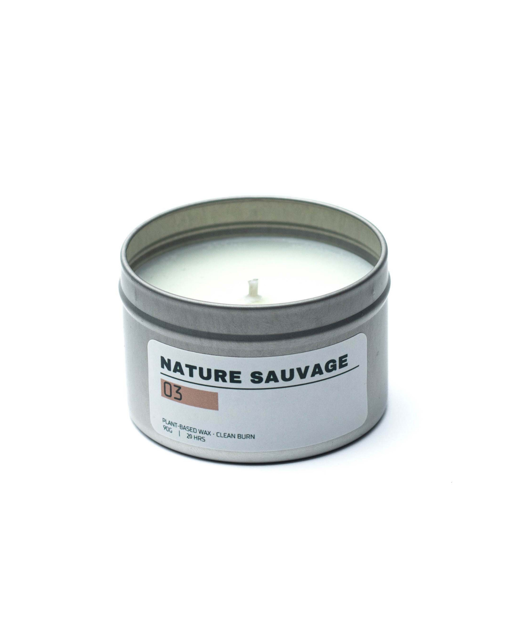Candle in a metal tin labeled 'Nature Sauvage' on a white background
