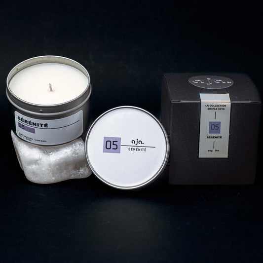 Candle in a tin with packaging on a dark background