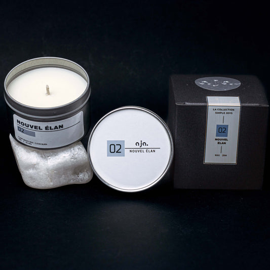 Candle with packaging and label on a dark background