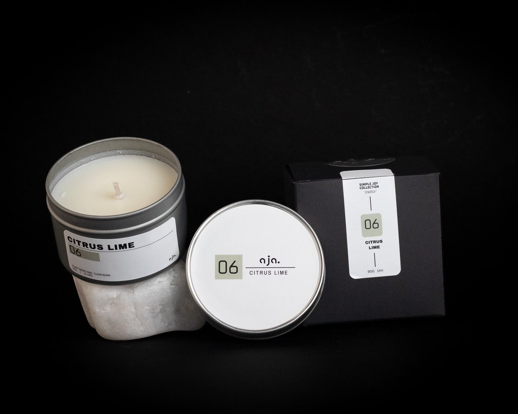 Candle with packaging on a black background