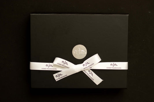 Black gift box with a white ribbon and 'nja' branding on a black background