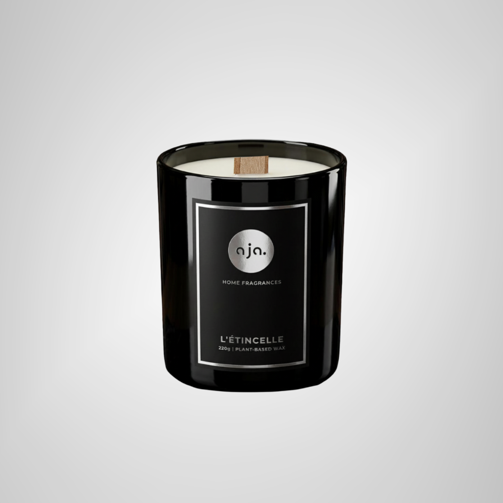 Black candle with a label on a light gray background