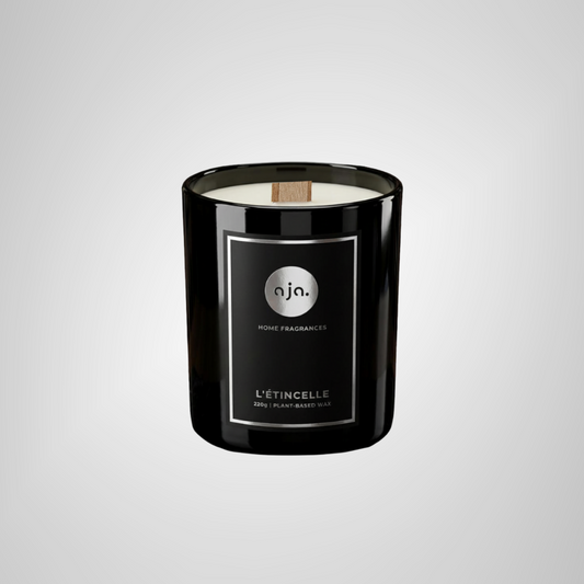 Black candle with a label on a light gray background