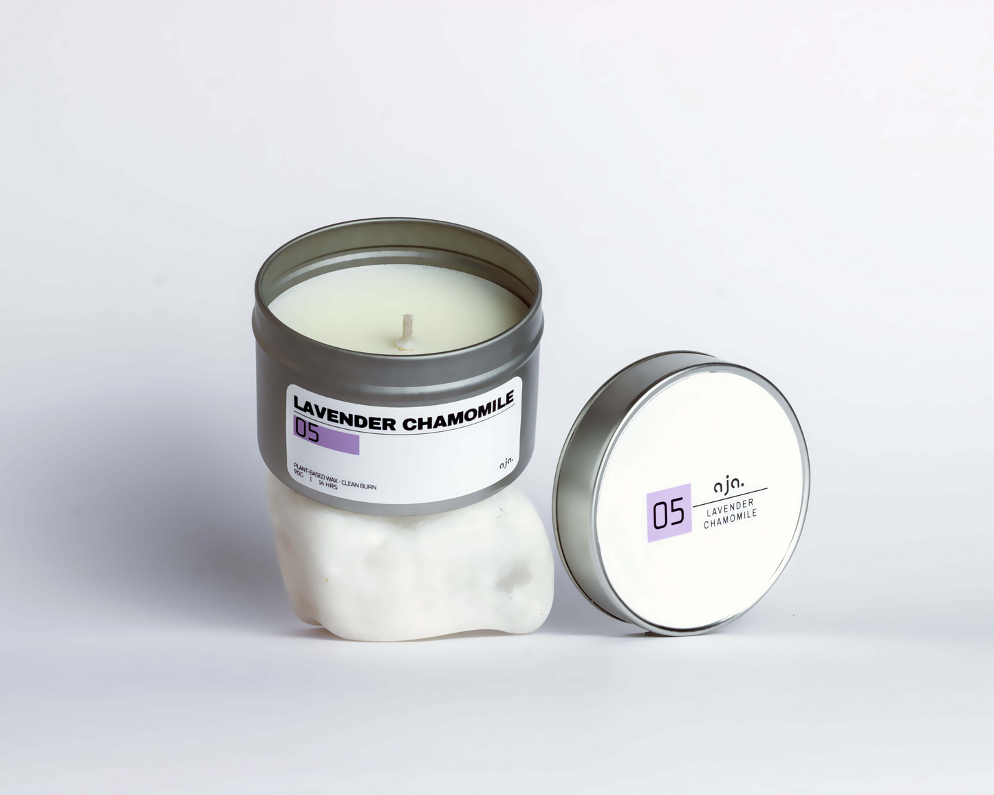 Candle with a metal lid labeled 'Lavender Chamomile' on a white background
