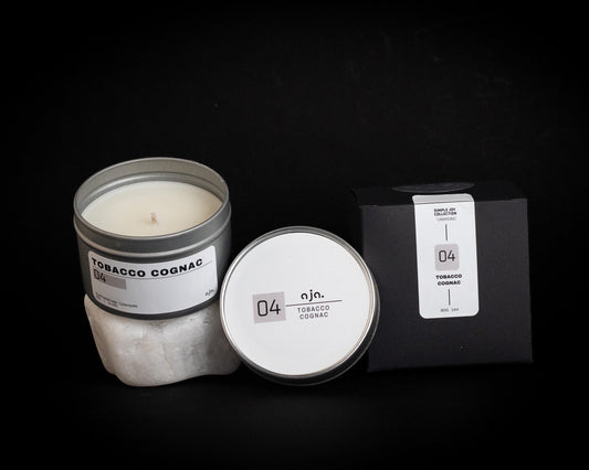 Tobacco Cognac candle with packaging on a black background