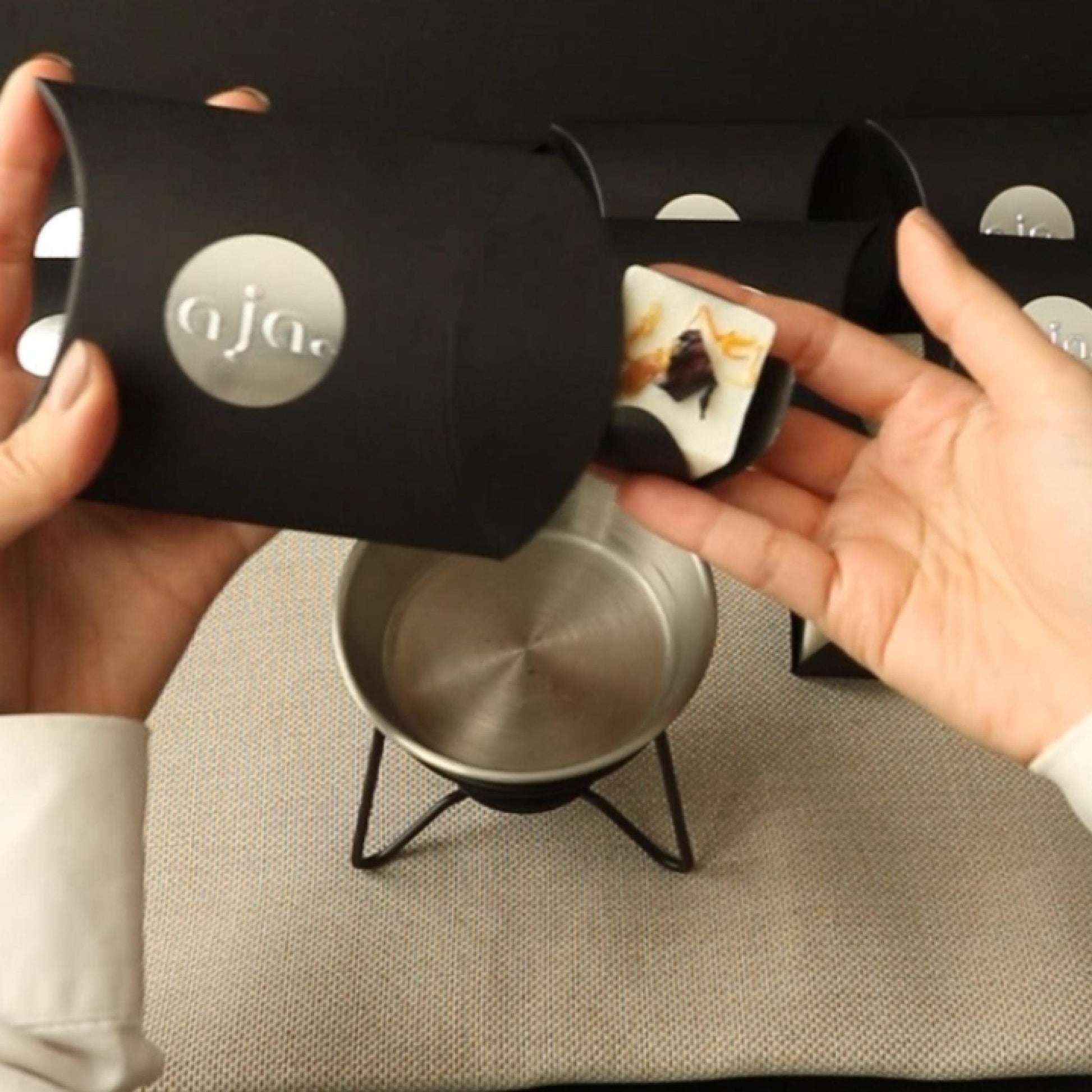 Product packaging demo of wax melt cube with botanical on top